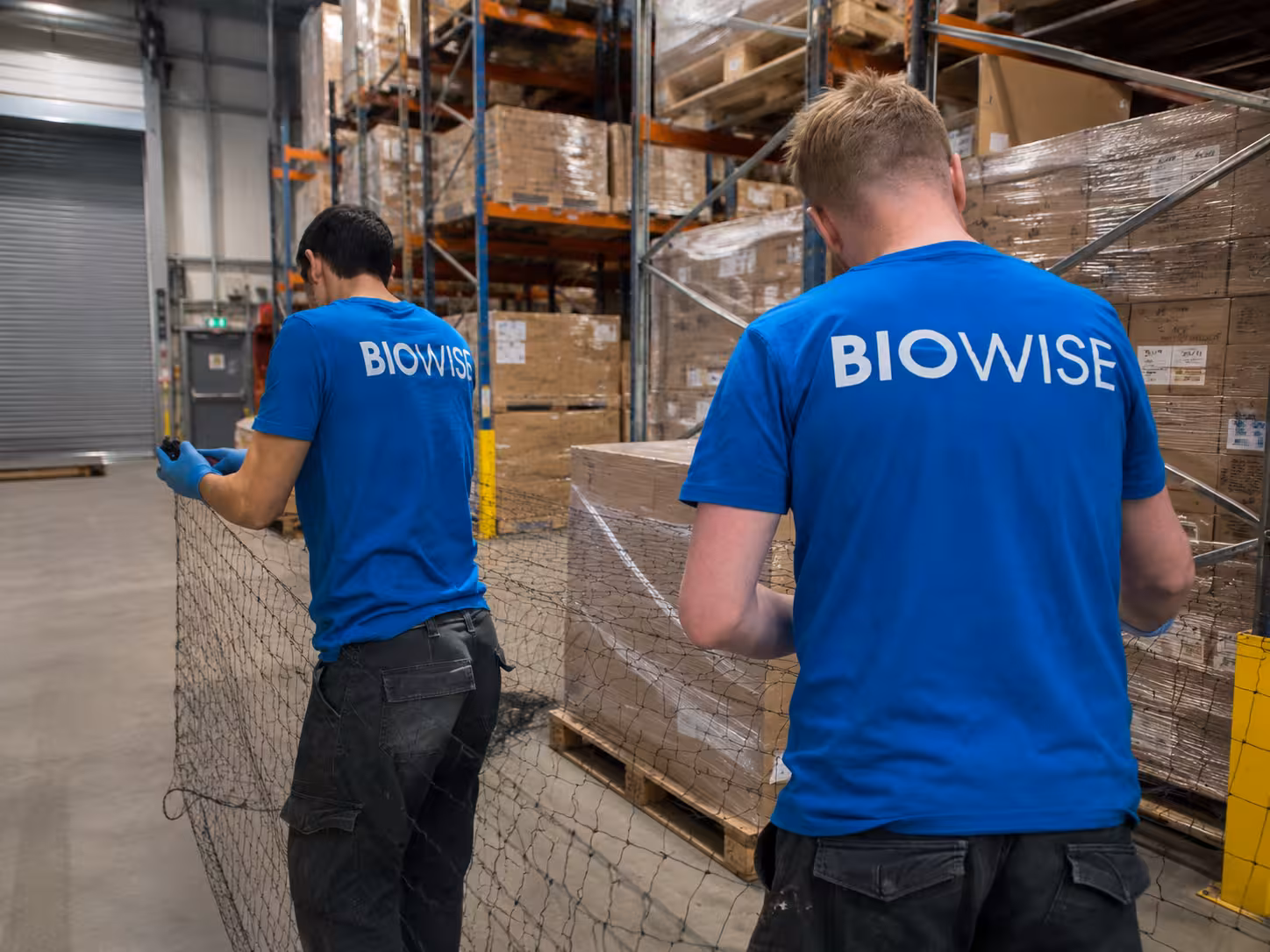 BioWise technician checking a bait station in a London warehouse loading bay