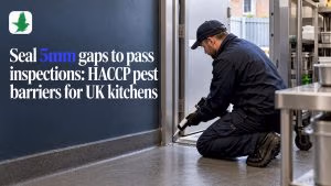 Technician sealing kitchen door-frame pest gap